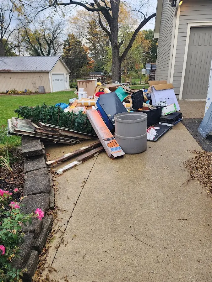 Dumpster being loaded with debris for 30 Yard Dumpster Rental in Tiptonville